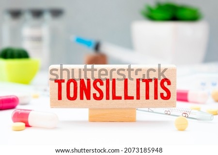Tonsillitis word, medical term word with medical concepts in blackboard and medical equipment.