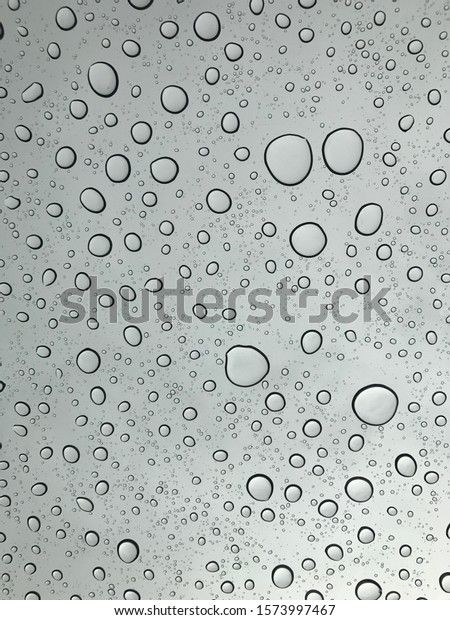 I took this picture sitting in my car. It had\
just stopped raining and I noticed big water droplets resting on my\
sunroof. I took the picture with the sky in the background. The\
rest is history.