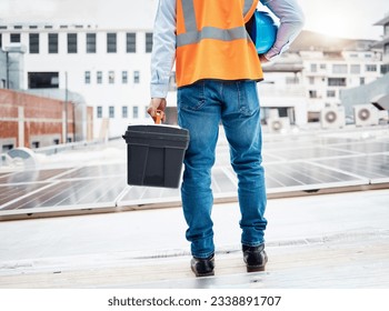 Tool box, construction worker and back with solar panel maintenance and labor outdoor. Roof, eco engineer and green energy project with builder and sustainability contractor with building project