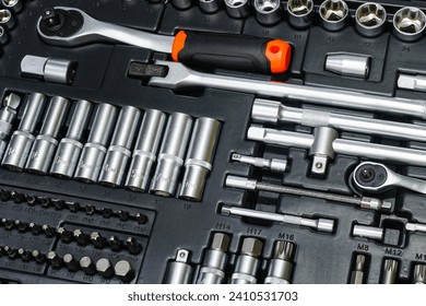 Tool box, tool kit closeup with set of hex, torx and screwdriver bits and ratchet wrench sockets