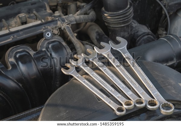 tool for\
car repair on the background of the\
engine