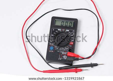 Tool for checking electrical equipment and electrical circuits. Digital multimeter on white background.