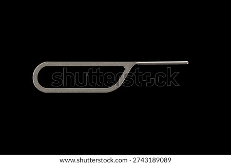Tool for eject SIM card phone isolated on Black background