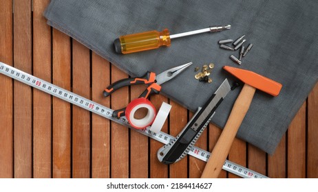 Tool Kit On Wooden Background Screwdriver, Hammer, Wire Cutters