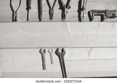 Tool set and instruments for hand work and fixing on wooden surface background. Close up top side view mockup design production details Black and white photography image