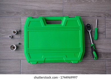 Tool Set. Large Box With Metal Tools. A Set Of Screwdrivers With A Large Number Of Parts. Male Tool Kit. Shiny, Silver Metallic Details In A Green Box On A Wooden Background