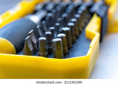 Tool Set. Large Box With Metal Tools. A Set Of Screwdrivers With A Large Number Of Parts. Male Tool Kit. Shiny, Silver Metallic Details Close-up In A Green Box On A Wooden Background