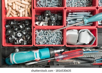 Toolbox with different instruments. Screws and screwdriver Plactic box with tools. Furniture assembly and renovation work concept