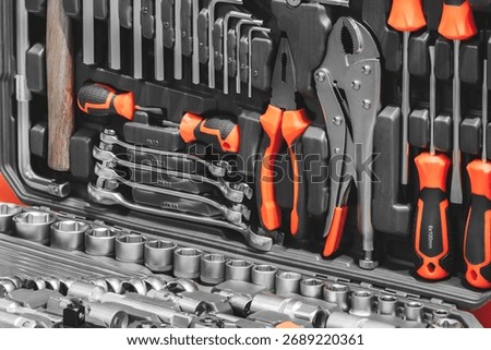 A toolbox full of tools including wrenches, pliers, and screwdrivers. The tools are organized and ready for use