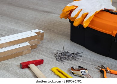 Toolbox With Various Work Tools On A Wooden Floor. Text copy space.
