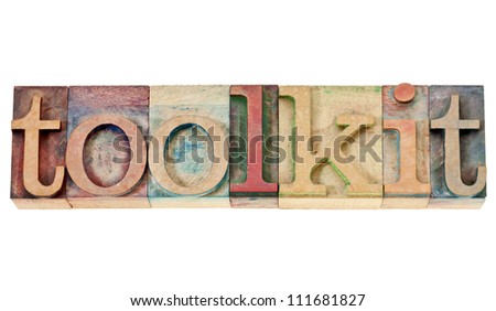 toolkit -  a set of tools or software -isolated word in vintage letterpress wood type stained by color inks isolated word in vintage letterpress wood type stained by color inks