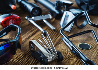 Tools and accessories set for cycling. Accessories for bicycles trips: universal screwdriver tool  and screws, glasses, bicycle mirror, pump, water holder, speedometer. Bike tools and spares. 