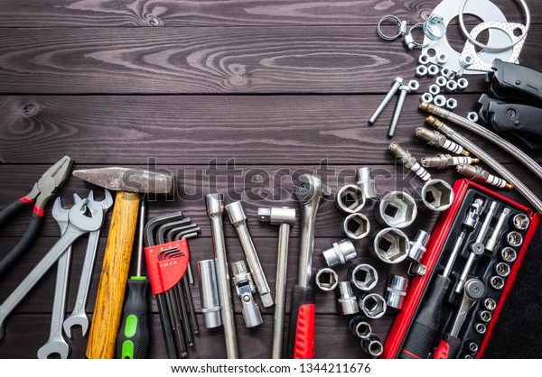 tools and auto spare parts on wooden workbench.\
copy space