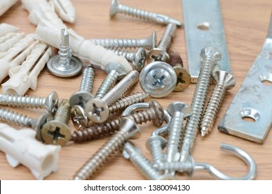 Tools And Auto Spare Parts As Well As Sleeve Anchor Bolts ,nuts,screws,Fixing DIY On A Wooden Work  Bench Surface.