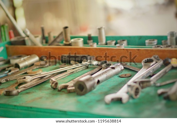 Tools for car service. Screwdriver and wrench in car\
service room. Mechanic tools for maintenance car in garage.Close\
up.