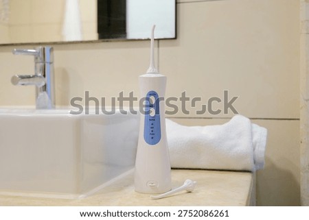 Tools for cleaning teeth in the bathroom. Portable mouth irrigator and dental floss. Zero waste, sustainable bathroom and lifestyle.