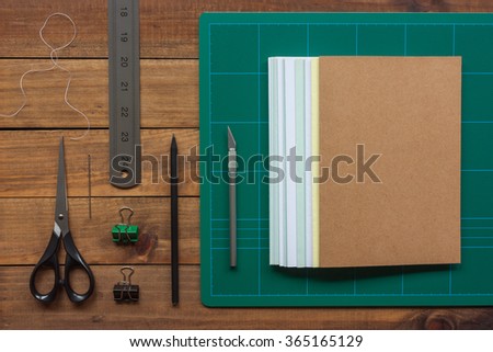 Tools for the craft of hand bookbinding on wooden table