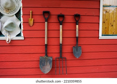 Tools And Equipments Farm Gardening On Red Wooden Wall Of Barn Farmhouse For Farmer Use Growing Cultivating Horticulture At Meadow Rural Countryside In Nonthaburi, Thailand