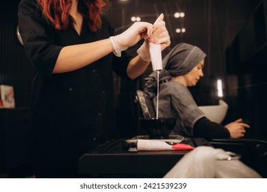 Tools for hair dyeing in woman hands. Colouring of hair at home. High quality photo - Powered by Shutterstock