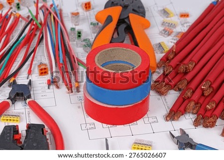 Tools and materials for assembling an electrical switchboard in the workplace.