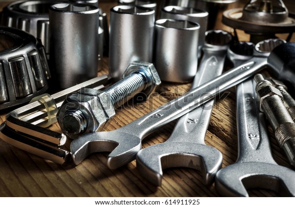 tools and old\
auto parts on wooden\
background
