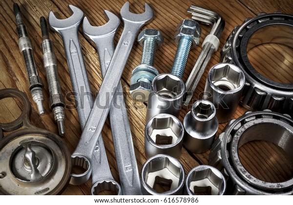 tools and old\
auto parts on wooden\
background