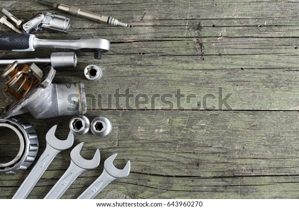 tools and old
auto parts on wooden
background