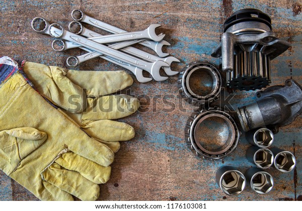 Tools, old auto\
parts and protective\
gloves