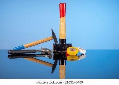 Tools For Repair And Construction, A Sledgehammer And A Pair Of Hammers, Colored Electrical Tape. Do It Yourself Concept, Sale Of Goods For Renovation And Construction, Home Renovation Services.