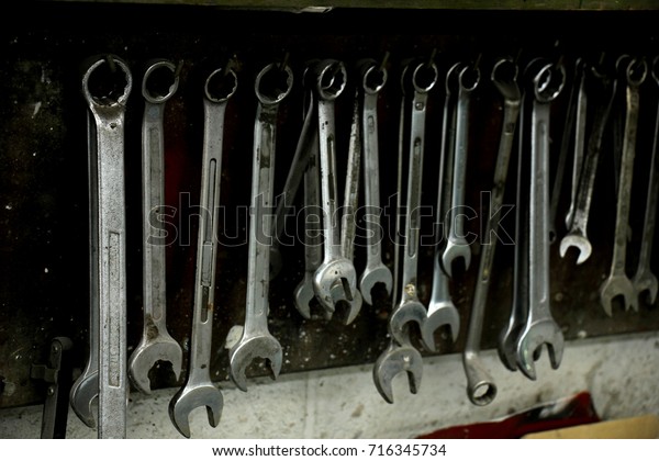 Tools\
in a repair shop, socket wrenches in various\
sizes
