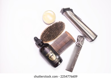 Tools to take care of the beard. Wax, comb, brush, electric trimmer and balm on white background. Top view. Flat lay. Copy space. - Shutterstock ID 2254776609