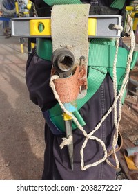 The tools are tied with secure lanyard to prevent dropped object from work at height activities on construction field.