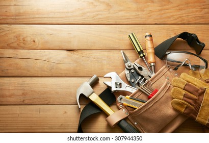 tools in tool belt on wood planks with copy space - Shutterstock ID 307944350