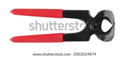 Tools - Top view closed carpenter's pincers with red handles isolated on a white background.