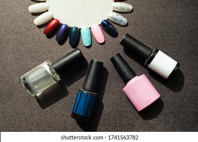 Tools For UV Light Manicure/pedicure. Set Of Gel Nail Polish On Black Background. Base Coat, Top Coat And Colorful Layout.