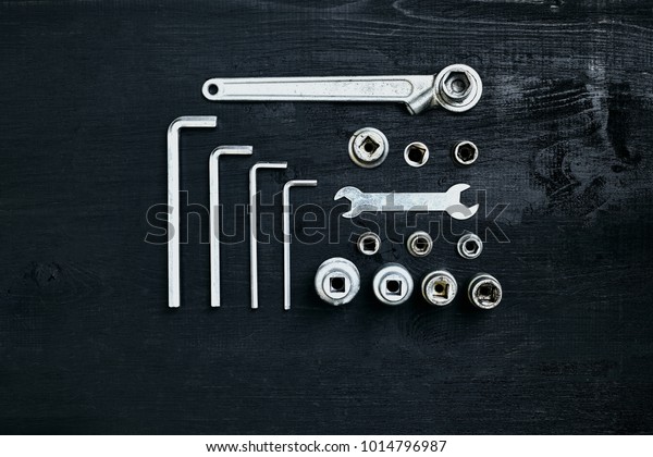Tools for work or repair auto on black wooden\
background. Top view