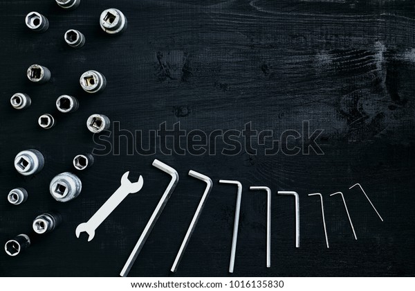 Tools for work or repair auto\
on black wooden background. Top view. Still life. Copy space. Flat\
lay