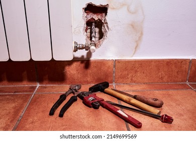 Tools Of The Worker Sent By The Homeowner's Insurance Company To Repair The Damage Caused By A Water Leakage From The Heating System In The Wall Of A House.