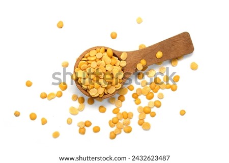 Toor dal or split yellow lentils in a wooden spoon isolated. Split Chickpea in a Bag Also Know as Chana Dal, Yellow Chana Split Peas, Dried Chickpea Lentils or Toor Dal isolated on white Background