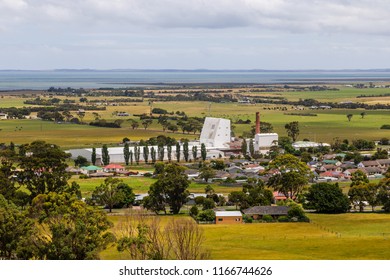 Toora, Victoria, Austrlia - December 20 2017: Remote View Of The Village With ViPlus Dairy Plant (big White Building) And The Corner Inlet Marine And Coastal Park Int He Background.