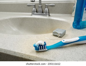 Tooth Brush, Dental Floss And Mouthwash On The Bathroom Sink                               