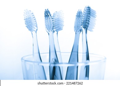 Tooth Brush & Toothpaste In Glass On White Background