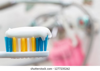 Tooth brush and white toothpaste close up