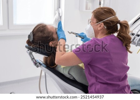 Tooth extraction using forceps, special dental instrument for teeth removal