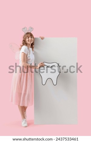 Tooth Fairy with paper figure and blank poster on pink background