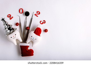 Tooth figurines and dental tool for christmas and new year 2023, top view. holiday medical concept - Shutterstock ID 2208416339