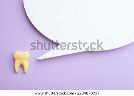 

Tooth Next to Speech Bubble Promoting a Marketing Message. Molar speaking making a commercial announcement for a dental clinic
