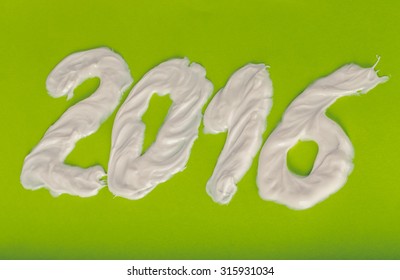 Tooth Paste In The Form Of Numbers 2016  On The Green Paper Background. Christmas Theme. Toned.