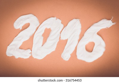 Tooth Paste In The Form Of Numbers 2016  On The Green Paper Background. Christmas Theme. Toned.