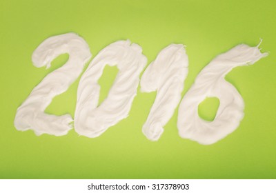 Tooth Paste In The Form Of Numbers 2016  On The Green Paper Background. Christmas Theme. Toned.